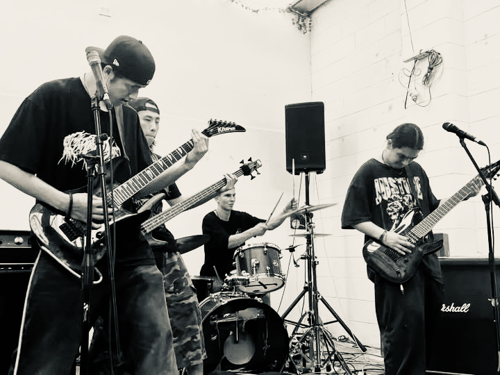 KNEED vocalist performing into a microphone at a live show